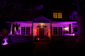 Halloween night lights decorating house with cemetery theme - Powered by Adobe