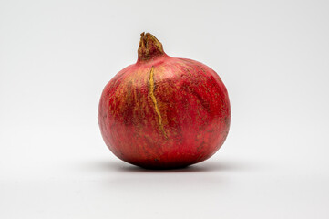 pomegranate with a scar on the skin isolated
