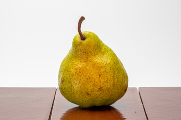 Pear Pakham with golden side  on brown tile