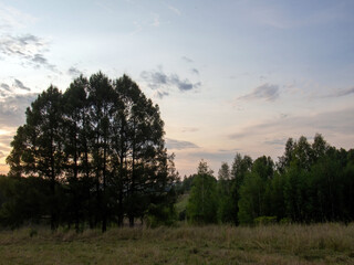 Fototapeta na wymiar sunset on a clear day over a wooded ravine