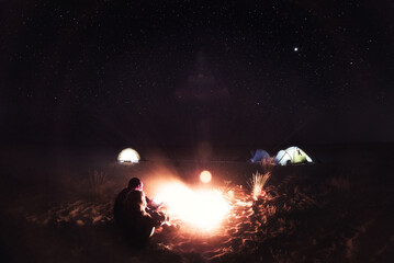 People and fire at night on the beach, Ukraine