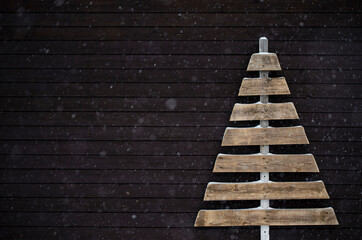 dark christmas background with wooden christmas tree