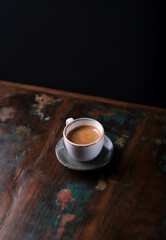 Cup of coffee on dark wooden background. Copy space. 