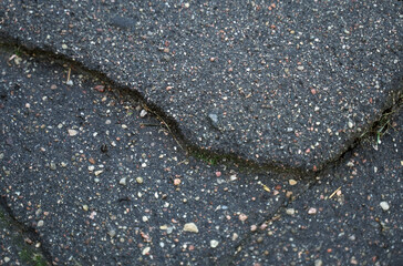 Cracked asphalt texture. View from above. Close-up