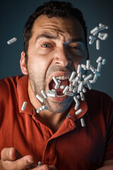 A tanned man in a medical mask. Lots of white pills. The coronavirus pandemic. Medicines in the man's hand.