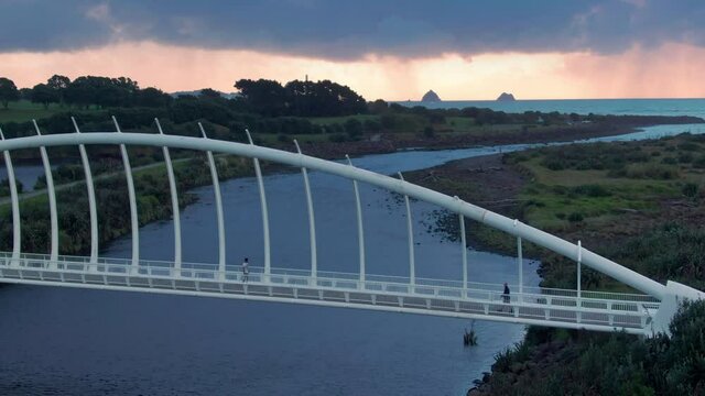 Aerial: Te Rewa Rewa Bridge at sunset, New Plymouth, Taranaki, New Zealand