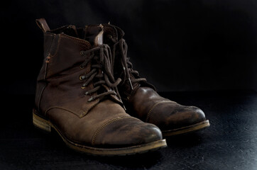Side View of Old Dusty Brown Leather Boots