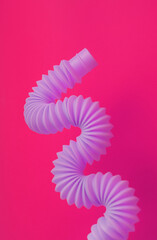 Colorful trendy toys pop tube on background