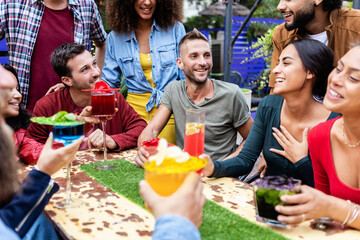 Group of friends enjoying trendy afternoon drinks at happy hours terrace bar - Cheerful multiracial...