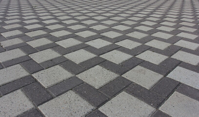 the ornament of the driveway laid out of different stone gray paving slabs