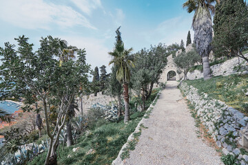 Ancient mediterranean park pathway in summer time.