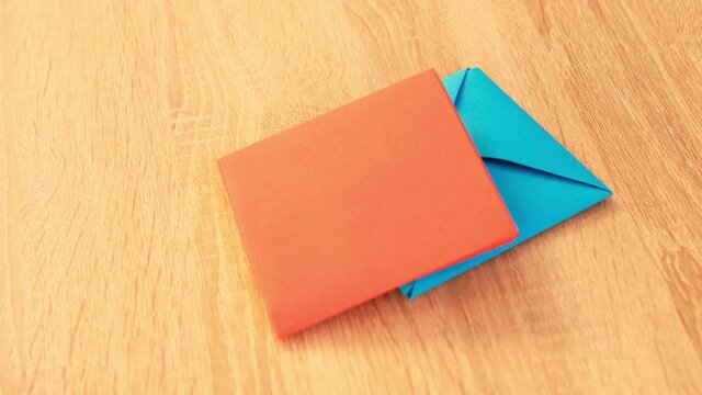 closeup fall on the table colored figures from paper, envelope in Japanese origami technique, concept of making and creating by hand for children's game