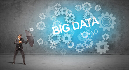 Fototapeta premium Businessman defending with umbrella concept