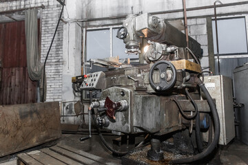 Old equipment milling machine for metal processing in the workshop of an industrial enterprise
