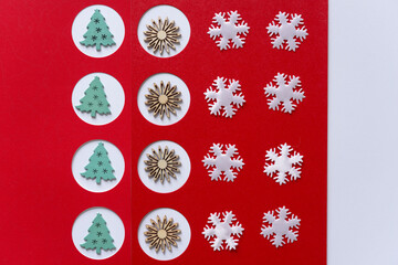 pattern with wooden christmas tree and starburst silhouettes with white fabric snowflake shapes on red paper