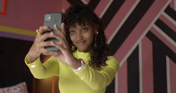Gen Z female taking a selfie with a smartphone