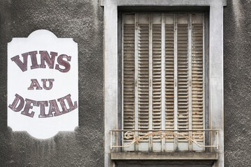 Old facade of a dealer with retail wines called vins au detail in french language