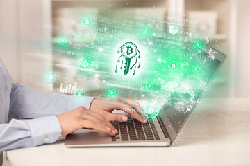 Young man watching stock market on laptop