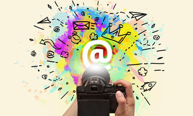 Close-up of a hand holding digital camera with abstract drawing concept