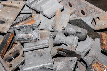 Iron parts of the workpiece for laying railway tracks metal structures in a heap at an industrial plant