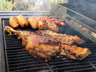 Cooking leg lamb and pork ribs in metal tray grilled. Food cooked grilling BBQ
