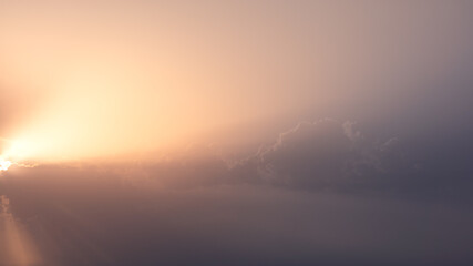 Wonderful view of cumulus clouds sky with orange sun light at sunset of summer