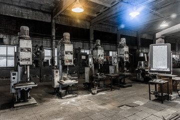 Old vertical milling machines equipment with flanged electric motors for metal processing in the...