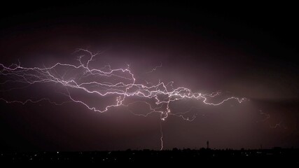 A real lightnings in the sky at night. Spectacular electrical storm clouds.