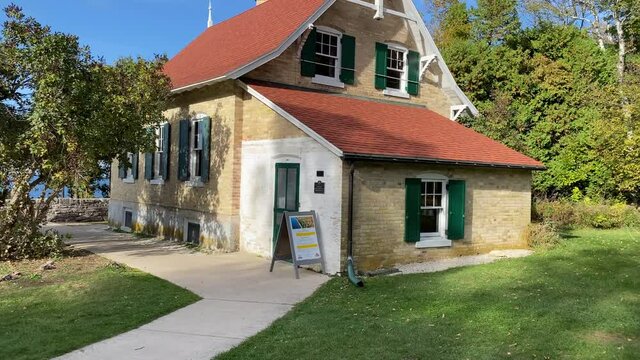 Panning shot of Eagle Bluff Lighthouse in Door County Wisconsin