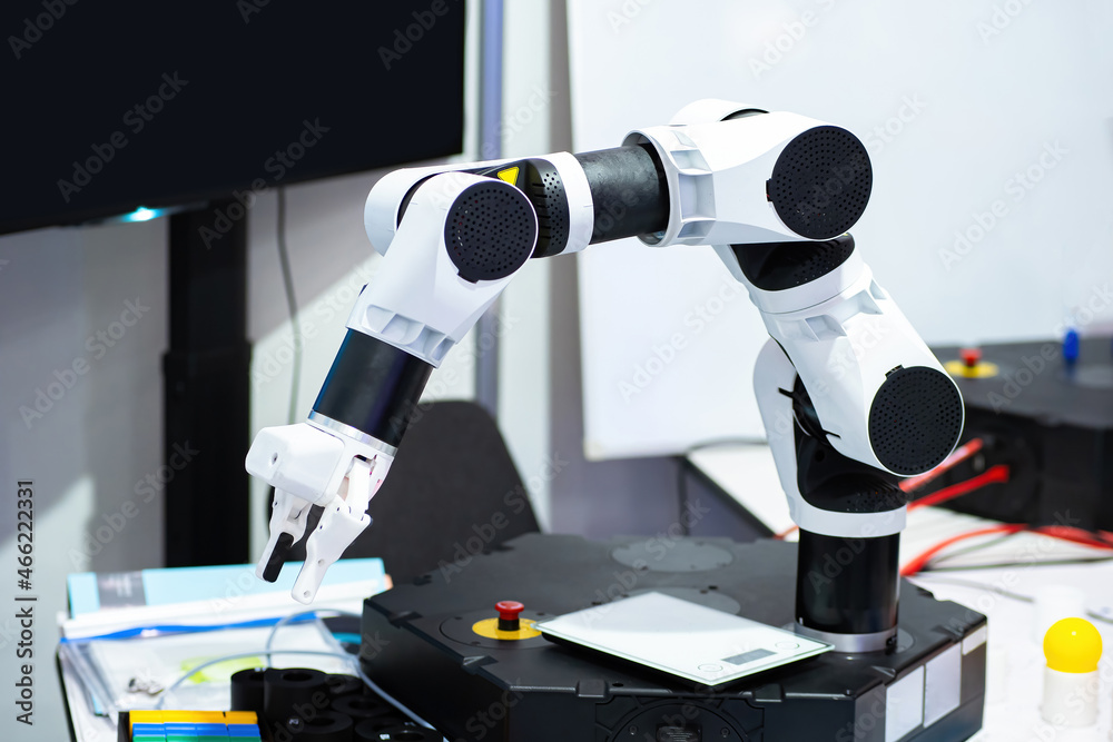 Poster small manipulator arm on table. hobby robotics. study robotics. robotic arm manipulator in technical