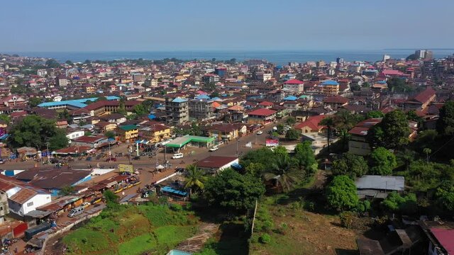 Aerial Freetown city congested building traffic part 1. Coast of west Africa suffers extreme poverty and hunger. Congested crowded homes and businesses. Tropical climate. Transportation bad roads.