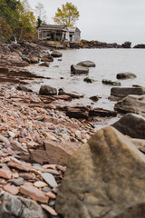 Abandoned fishing shacks or cabins, on Two Fishhouse Beach along Lake Superior shoreline in Minnesota, during fall