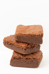 A pile of chocolate brownies isolated on white background.