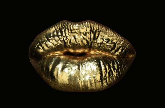 Gold lips. Gold paint from the mouth. Golden lips on woman mouth with make-up. Sensual and creative design for golden metallic. Isolated art background.