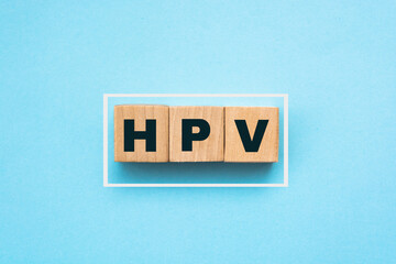 HPV Human Papillomavirus acronym on wooden cubes on blue. Healthcare concept. Sexual transmitted...