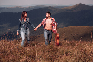 Young couple Camping. Lovers tourist walking. Young tourist couple travellers hiking in nature, walking and talking.