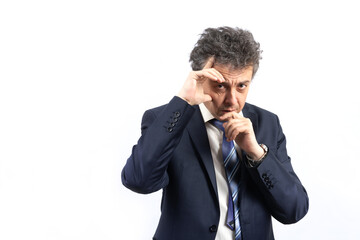 An unshaven middle-aged man in a business suit with disheveled hair and an emotional face looks...
