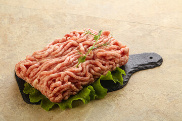 Raw minced pork meat over board