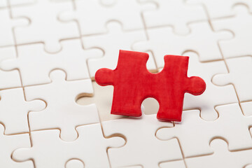Obraz premium a red piece of jigsaw puzzle ready to complete the mission.