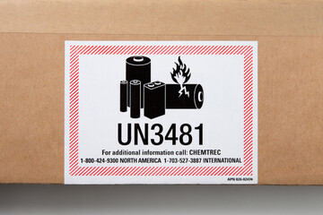 Close up of printed UN3481 sticker label about Lithium batteries are dangerous goods on packaging
