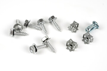 Turnkey fastening screws. Metal brackets for self-tapping screws. Close up. Isolated on white...