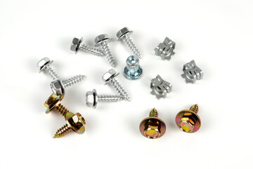 Turnkey fastening screws. Metal brackets for self-tapping screws. Close up. Isolated on white...