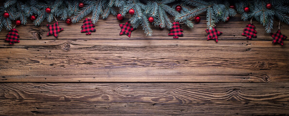 Cozy copy space background with spruce branches and Christmas tree ornaments on barn wood
