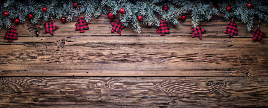 Cozy copy space background with spruce branches and Christmas tree ornaments on barn wood