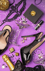 Flat lay stylish set: champagne, gifts, female sexy shoes, christmas balls and golden holiday decoration