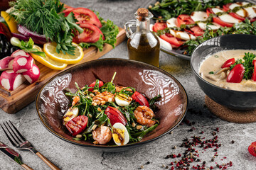 Various restaurant portions of salads on gray background