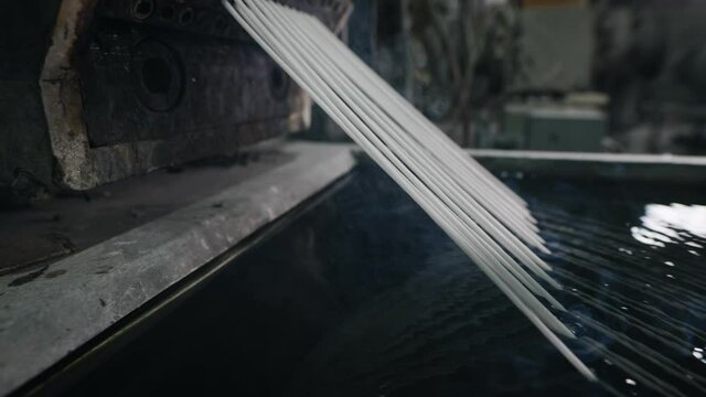 Technology for processing plastic waste into new polymers. Cooling strands in the frame.