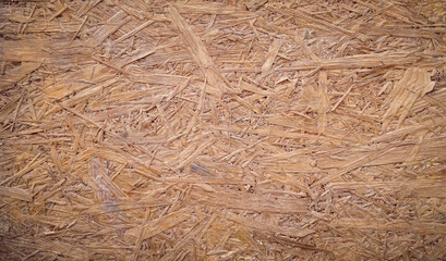 OSB panel texture, Sheet of plywood with fragments of compressed sawdust.
