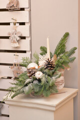 Eco christmas table decoration with candle, lobes and cones in wood sleight.