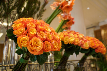 Obraz premium Orange roses. Bouquets of pink roses placed in vases. Photo inside